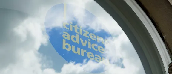 Photo of the Bureau logo in a window.