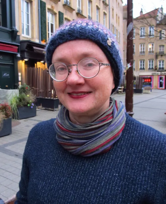 Al Swain - Team leader of the Health and Welfare advice service. Smiling with buildings in the background.